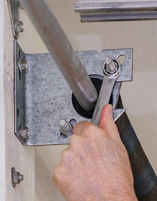 close up of a hand working on a garage door